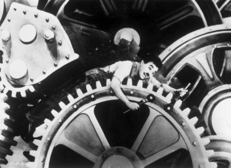 Charlie Chaplin in &#187;Modern Times&#171; (1936): der Mensch als Sand im &#246;konomischen Getriebe