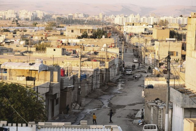 Die syrische Stadt Qamischli im Nordosten Syriens liegt direkt an der türkischen Grenze und ist eine der wichtigsten Städte in den kurdischen Selbstverwaltungsgebieten (Rojava). Im Hintergrund erkennt man die türkische Stadt Nusaybin, getrennt durch eine Grenzmauer.