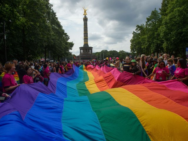 People march with huge pride flag during the Christopher Street Day in Berlin.