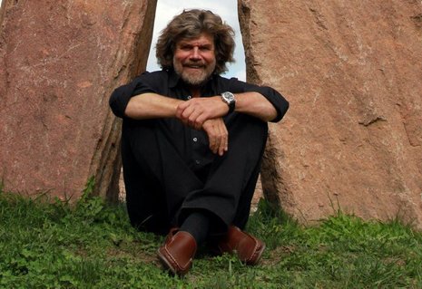 Reinhold Messner vor dem gigantischen Steinmann auf Burg Sigmundskron bei Bozen